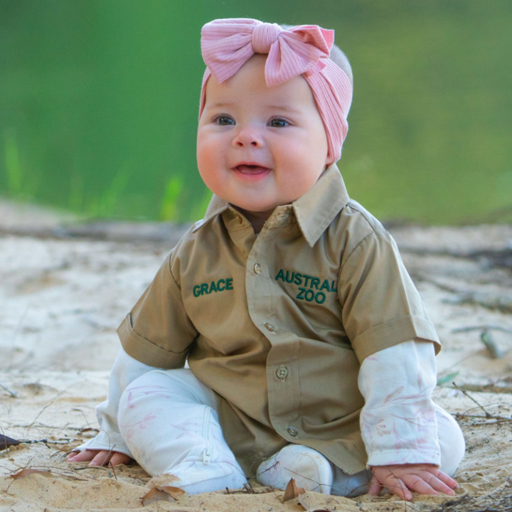 Bindi Irwin's daughter Grace sitting down and smiling
