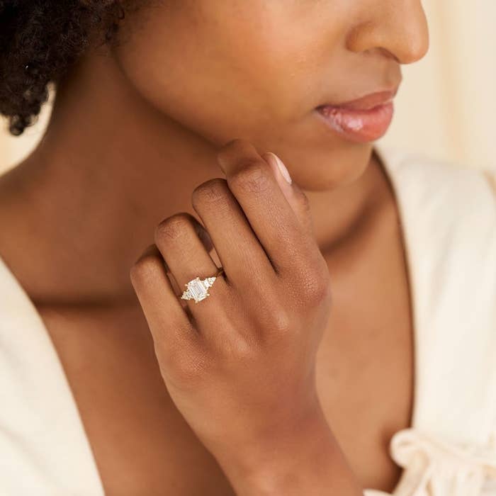 model wearing the emerald cut ring on their ring finger