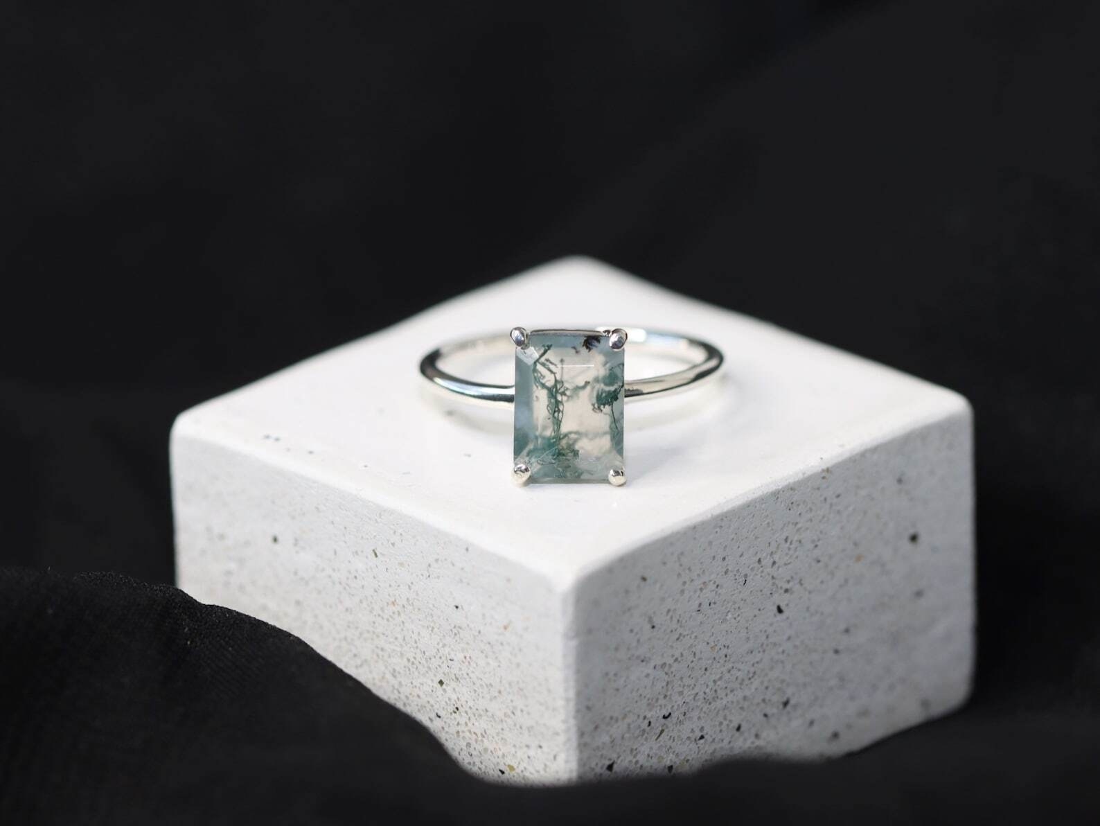 emerald cut ring with silver band and moss agate gem