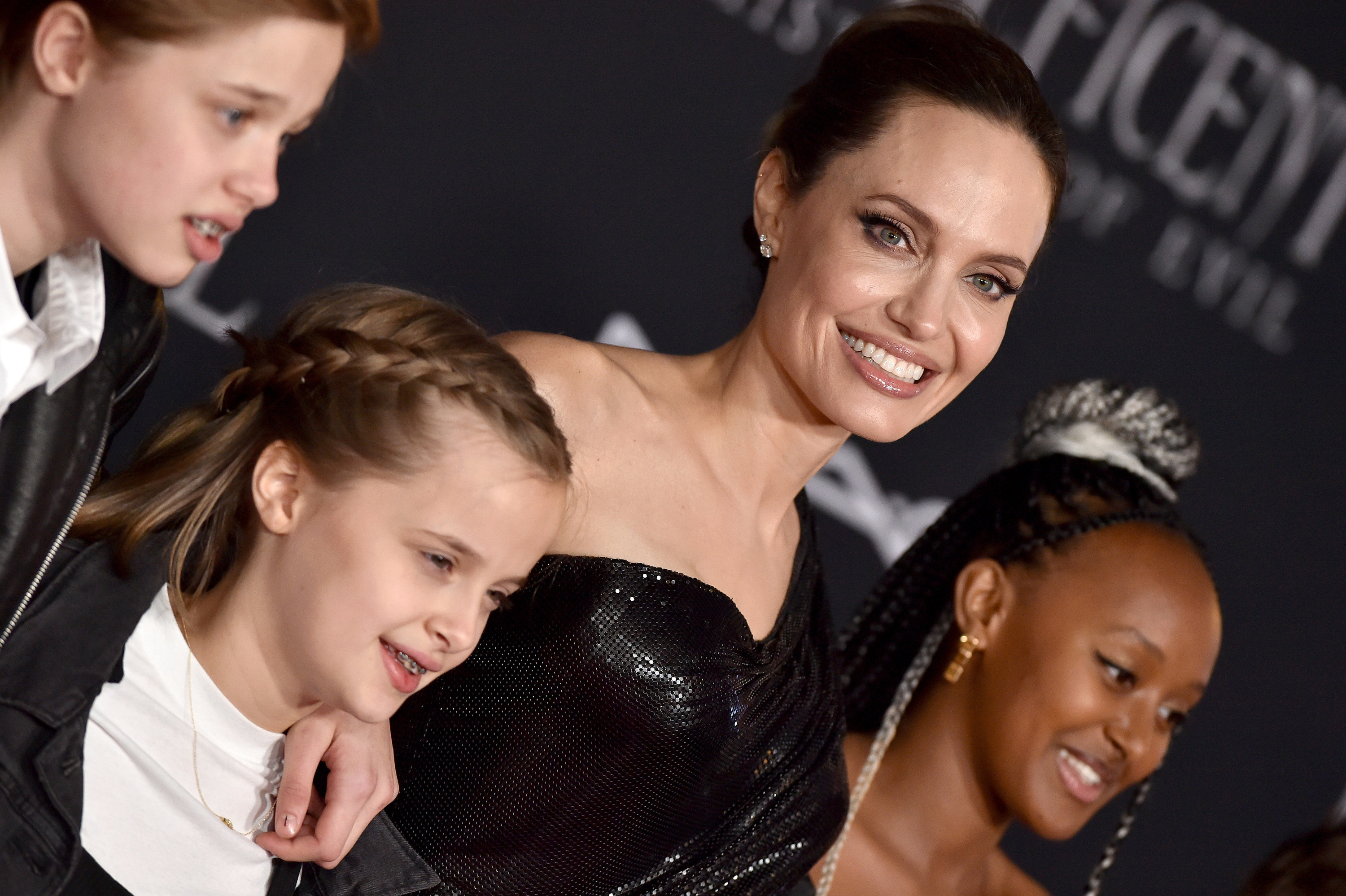A smiling Angelina on the red carpet with three of her children