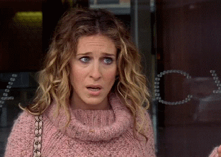 Carrie Bradshaw with a look of disbelief and confusion on her face