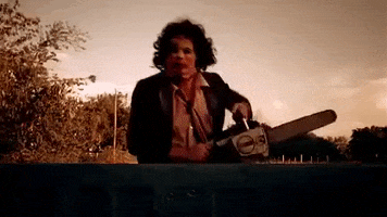 Masked man with a chainsaw chases a truck