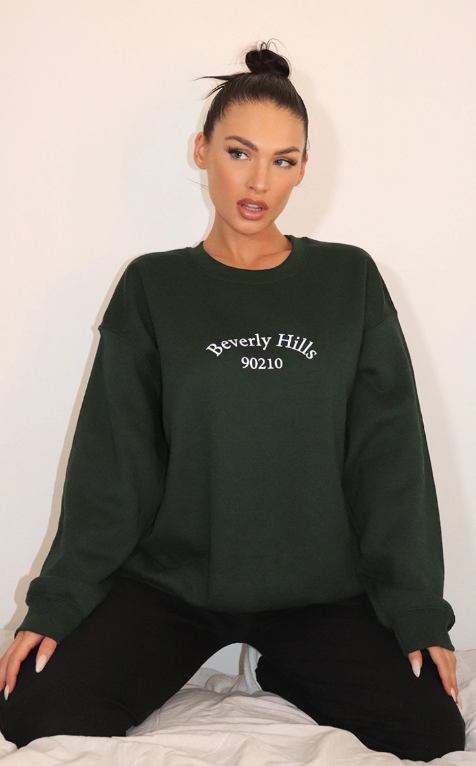 model wearing the forest green sweatshirt with beverly hills 90210 printed on it