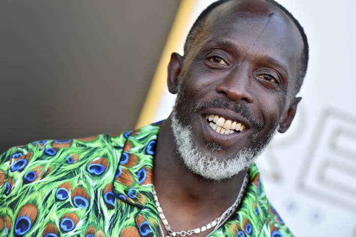 Michael, wearing a peacock feather–designed shirt, smiles