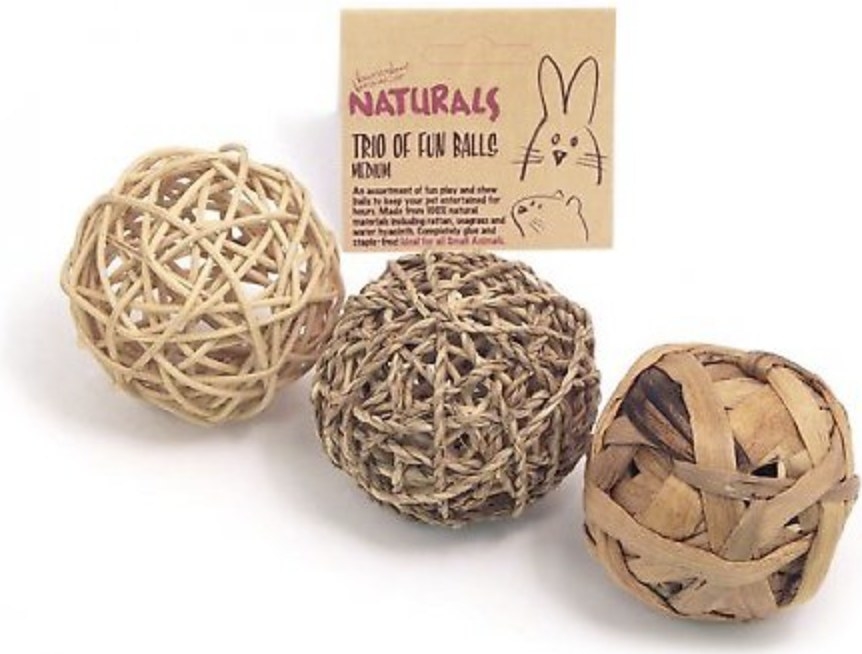 The three balls are made of rattan, seagrass and water hyacinth and have a nearby tag that says &quot;NATURALS&quot; and &quot;TRIO OF FUN BALLS&quot;