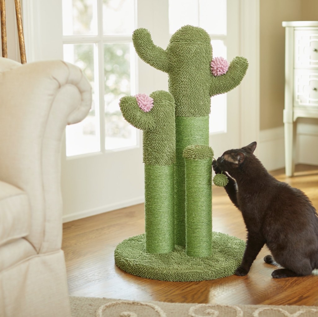 The tri-post has two large cacti with pink moppy flowers and a smaller green post