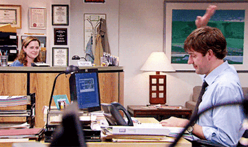 GIF of Pam and Jim from The Office doing air high fives at a distance