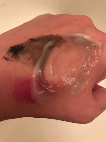 a reviewer showing how easily the cleanser removes makeup