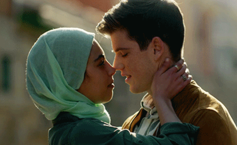 Nadia holds her hand on the back of Gúzman&#x27;s neck as they are about to kiss