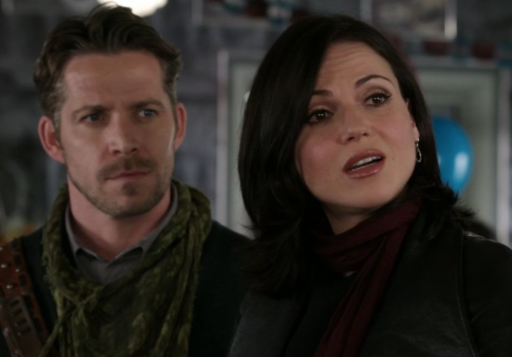 Robin stands behind Regina as she looks at someone off screen in disbelief