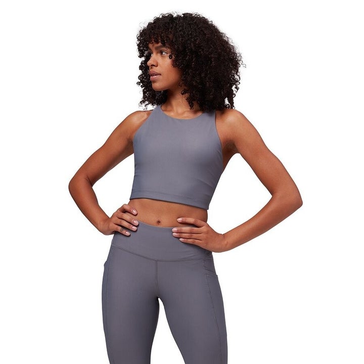 a model in a greyish purple high-neck sports bra