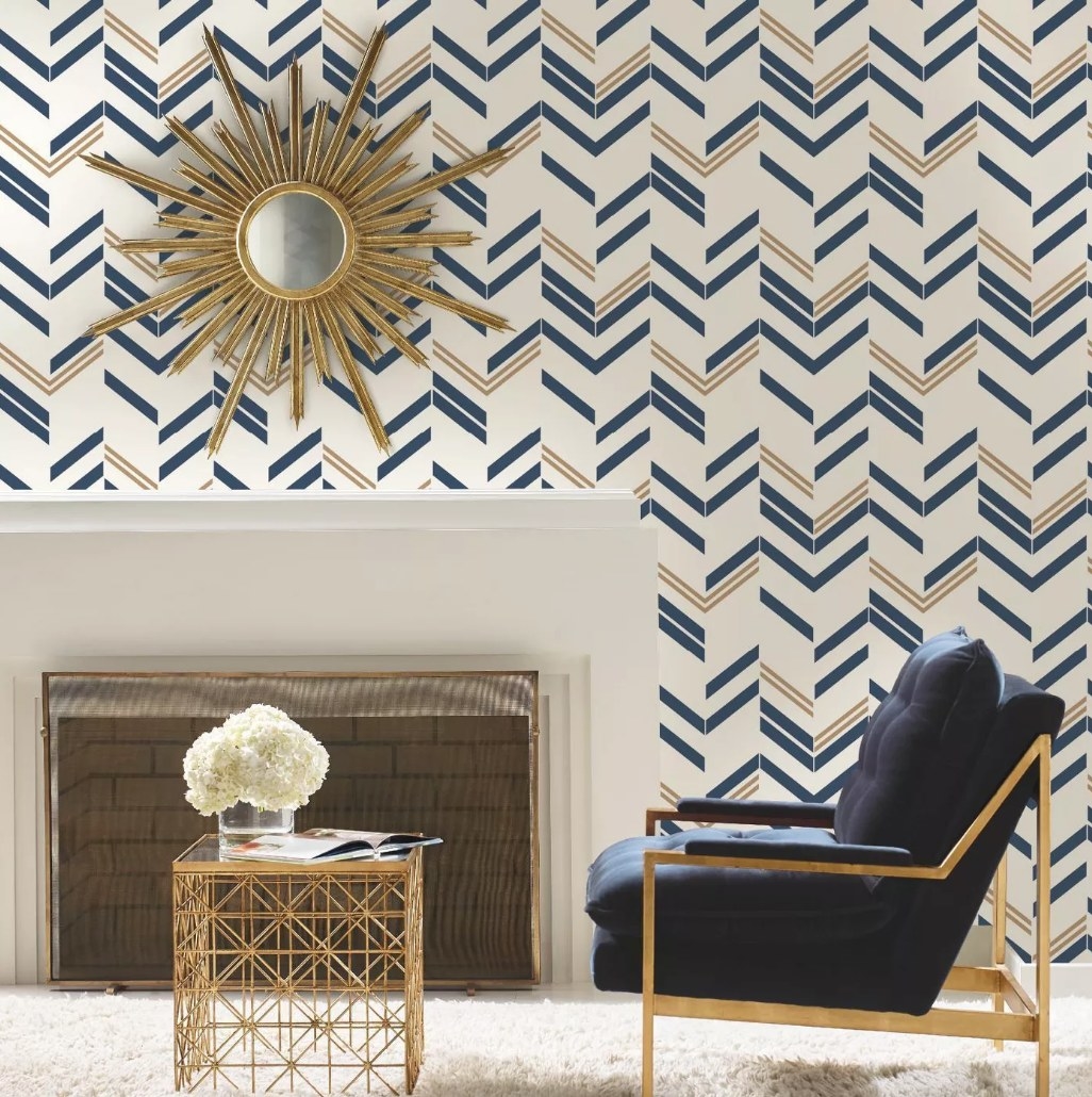 A blue/gold, chevron peel &amp;amp; stick wallpaper on the wall of a living room