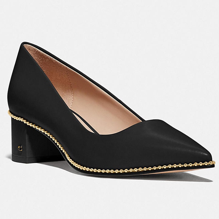 black pumps with gold detailing along the sole