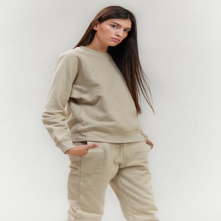 model wearing beige crewneck sweatshirt
