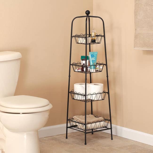 the four tier metal organizer holding toiletries in a bathroom