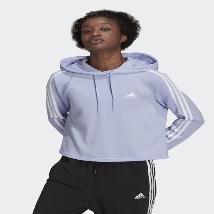 a model wearing a cropped light blue hoodie