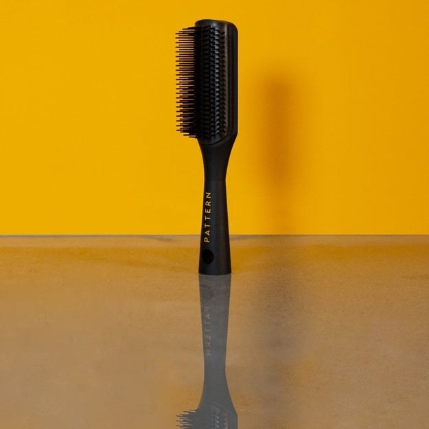 product image of shower brush against yellow background
