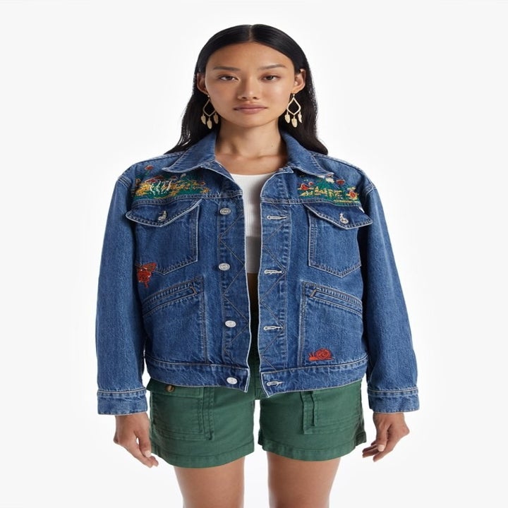 model in an embroidered denim jacket
