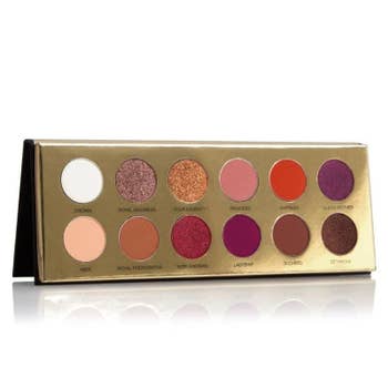 The 12 eye shadows in various shades of red, gold, purple, brown, and orange 