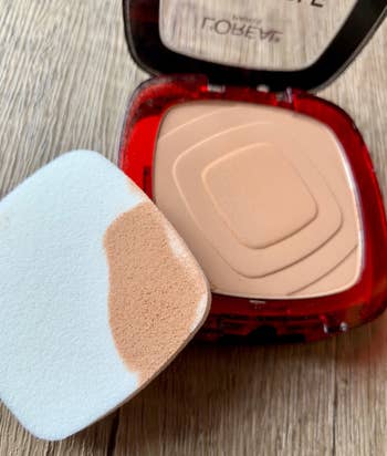 reviewer photo of the compact open showing the product, with the sponge with product on it