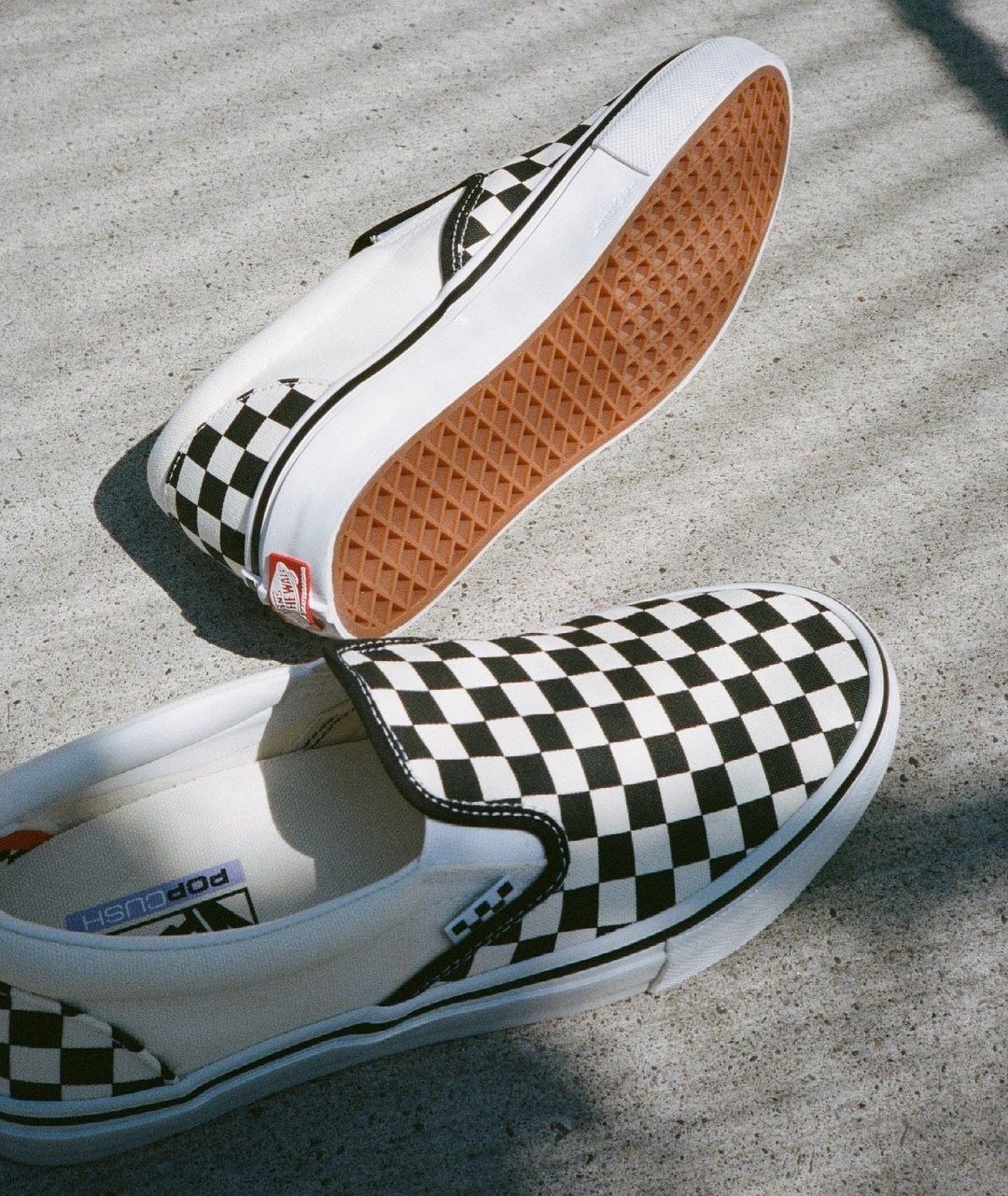 A pair of classic checkered vans slip on sneakers