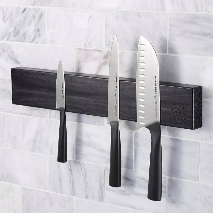 The wall bar with three knives on it