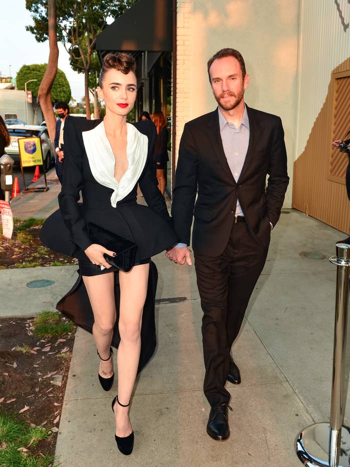 Lily wears as a hi-lo suit-style dress as she walks hand-in-hand with Charlie