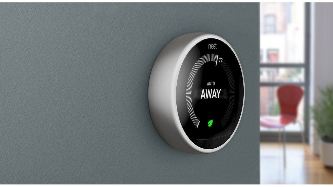 silver circular nest thermostat on a wall