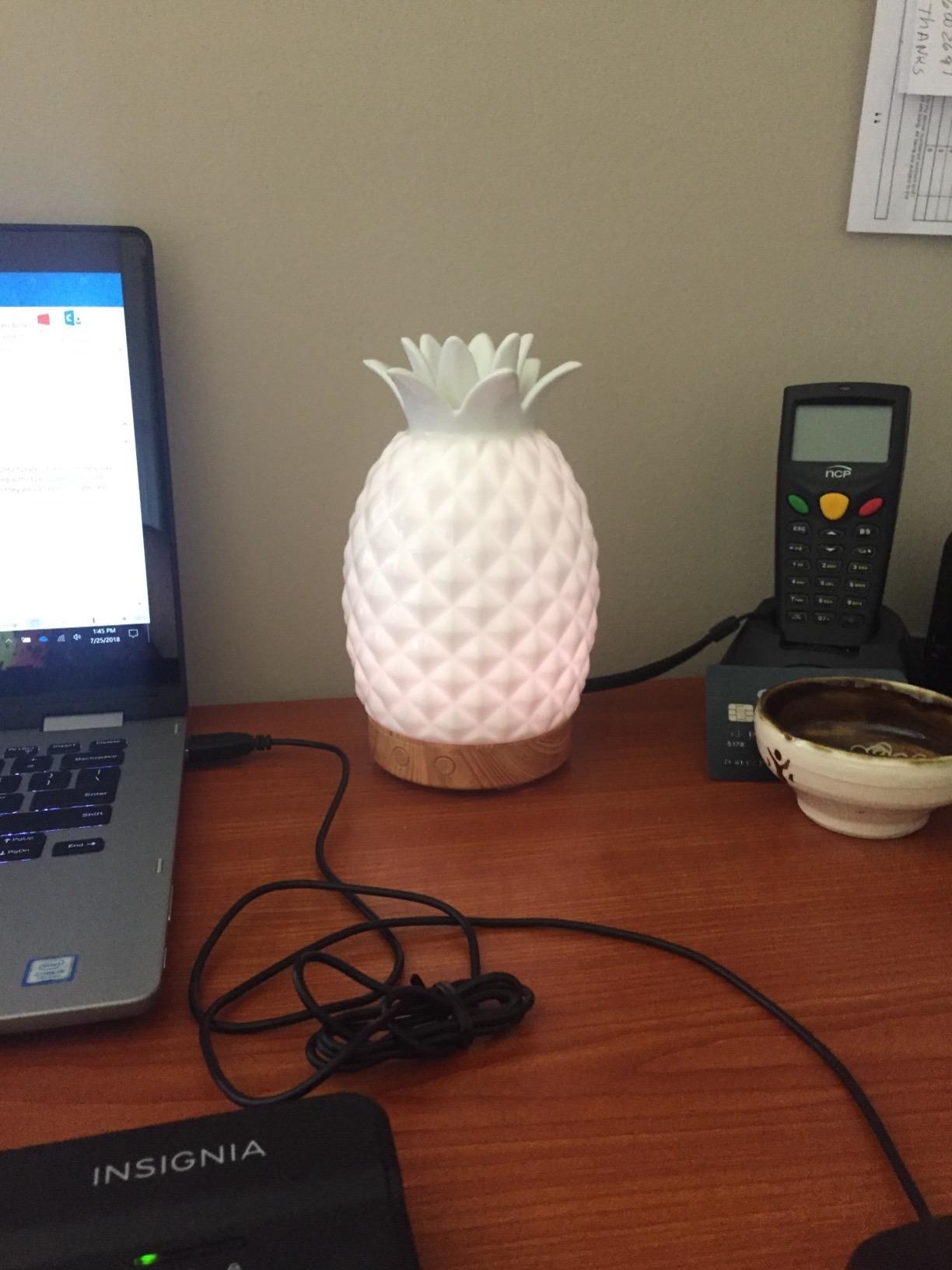 image of the pineapple diffuser on reviewer&#x27;s desk