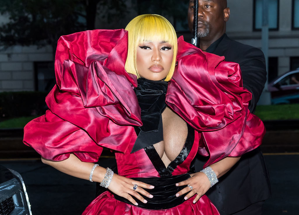 Nicki Minaj poses in an elaborate ruffled gown on her way into a fashion show