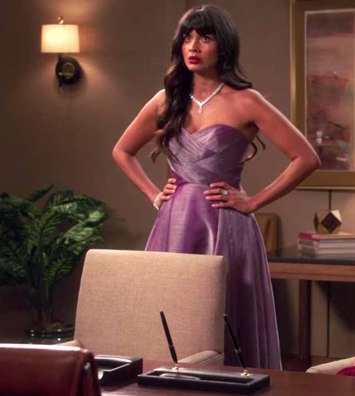 Tahani wearing a strapless gown