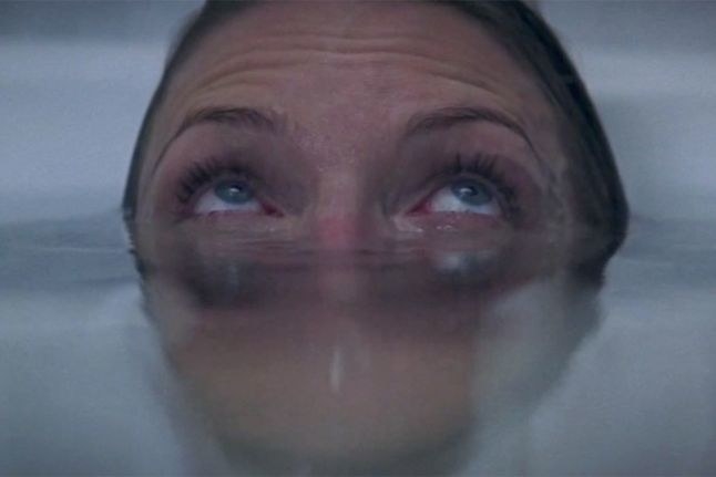 Woman eye-deep in a tub