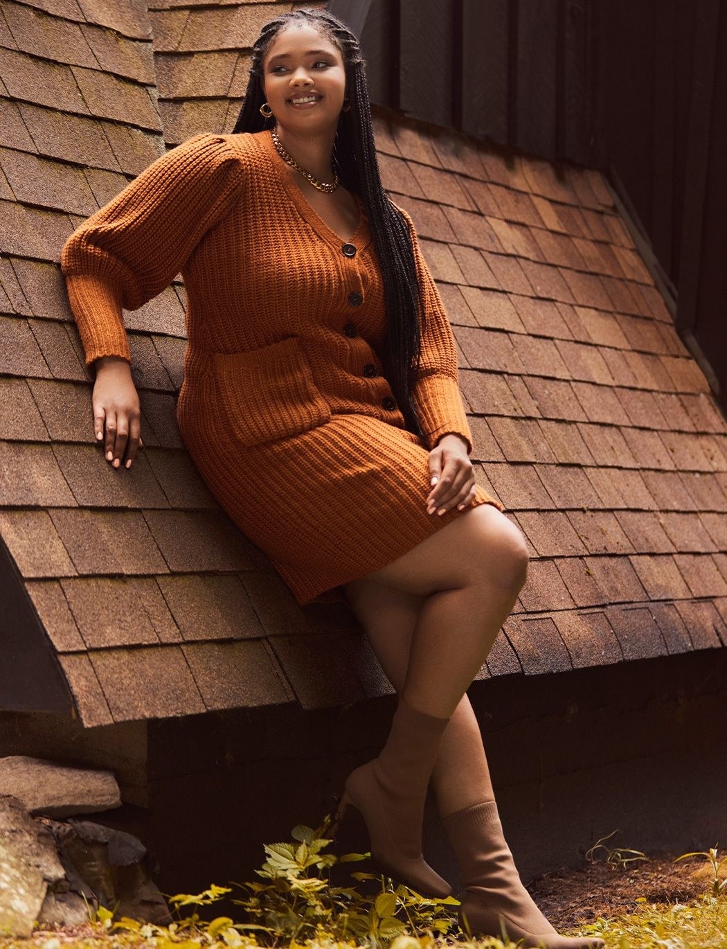 model wearing the dress in orange with heeled booties