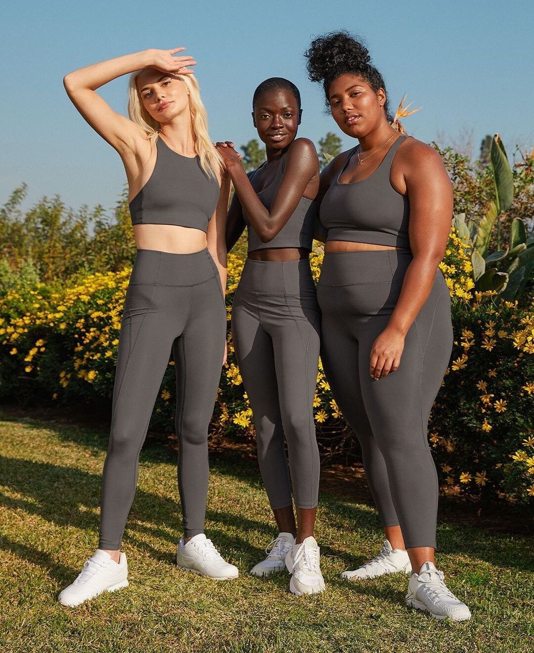 A trio of people all wearing the same pair of leggings