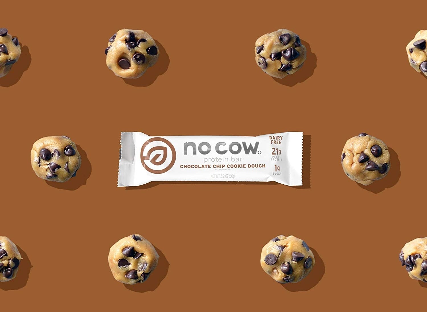 The protein bar on a brown background with cookie dough around it