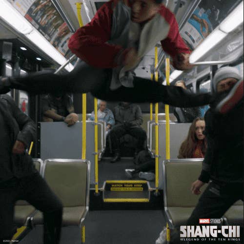 A person doing a perfect split in midair on a bus