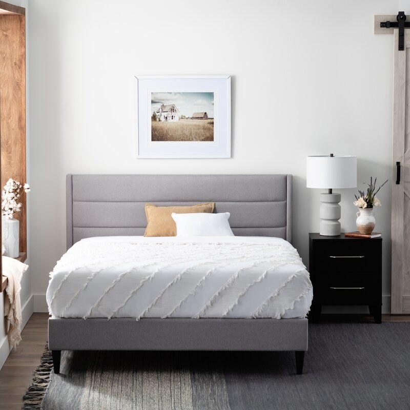 the grey colored upholstered bed frame