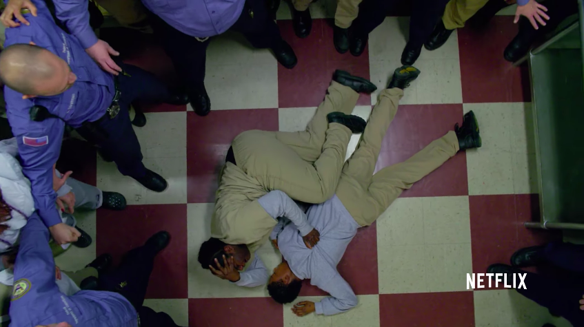 Taystee laying on the floor with Poussey&#x27;s body surrounded by guards and inmates on &quot;Orange is the New Black&quot;