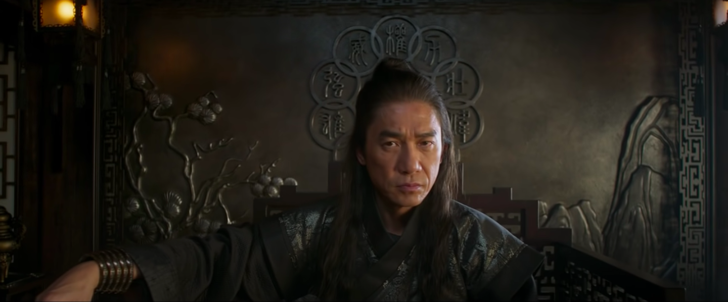 Wenwu looking serious sitting on a throne