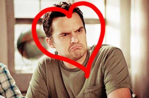 Nick Miller giving his patented turtle face with a red heart drawn around him