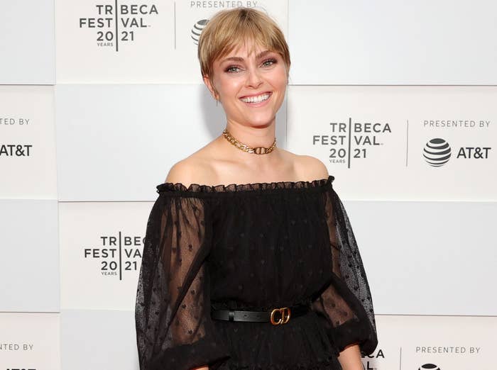 AnnaSophia smiles while wearing an off the shoulder black dress with puffy sleeves