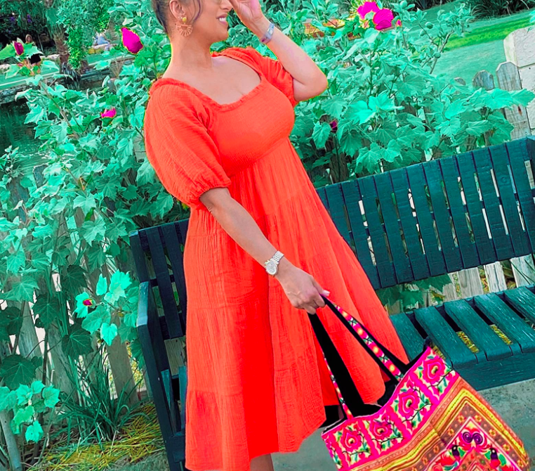 A customer review photo of them wearing the dress in orange