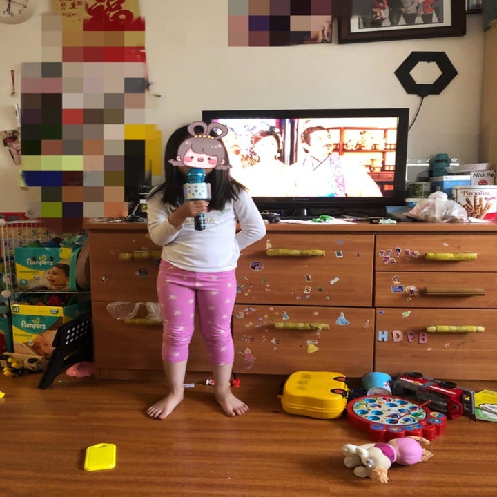 Reviewer's child holding the mic in blue