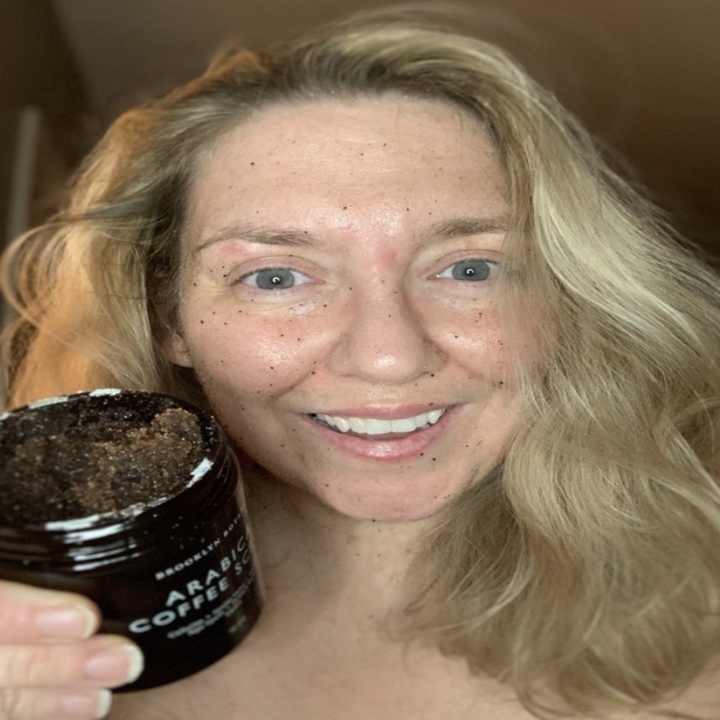 reviewer using scrub on skin