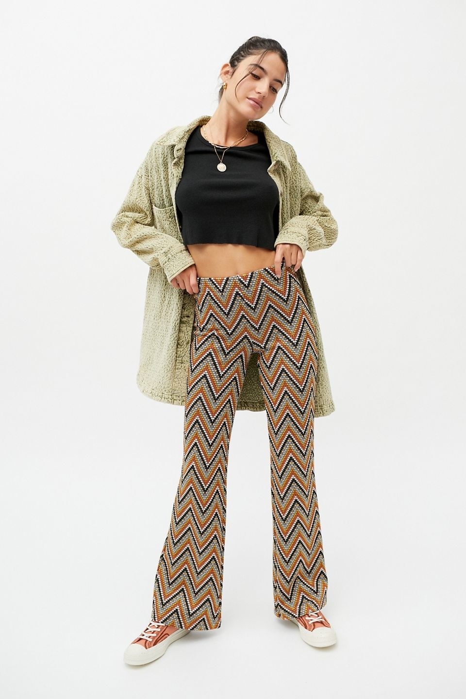 model wearing the orange and black zig-zag pattern pants