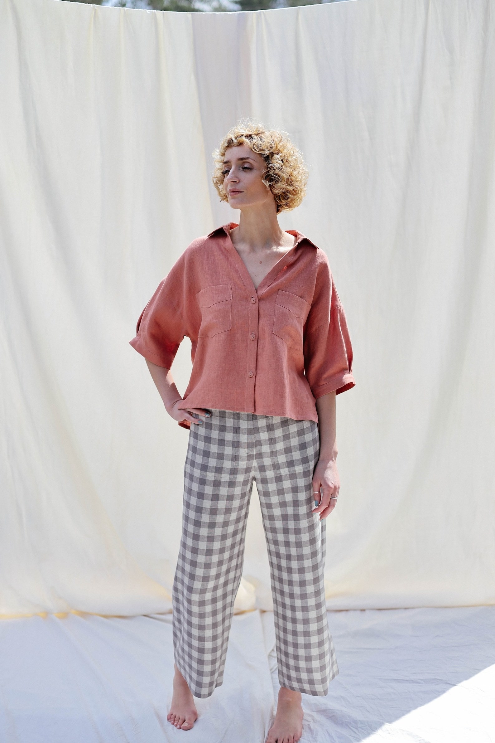 model wearing the ankle-length grey plaid wide-leg pants