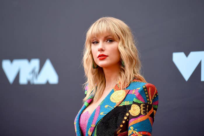 Taylor Swift in a colorful bedazzled outfit on the red carpet