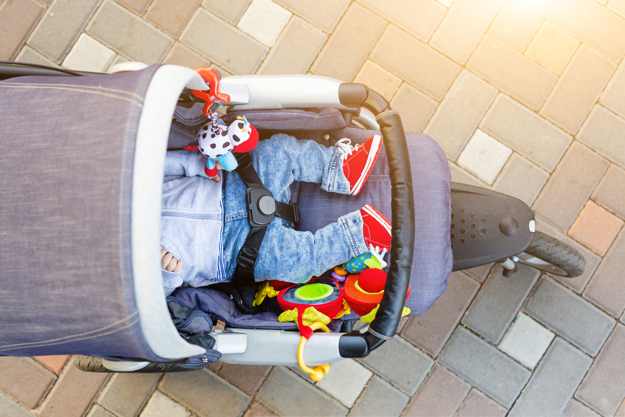 A baby sleeping in a stroller.