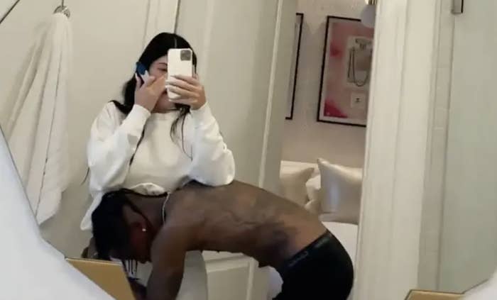 Travis holding his head to Kylie&#x27;s stomach as they read the pregnancy test