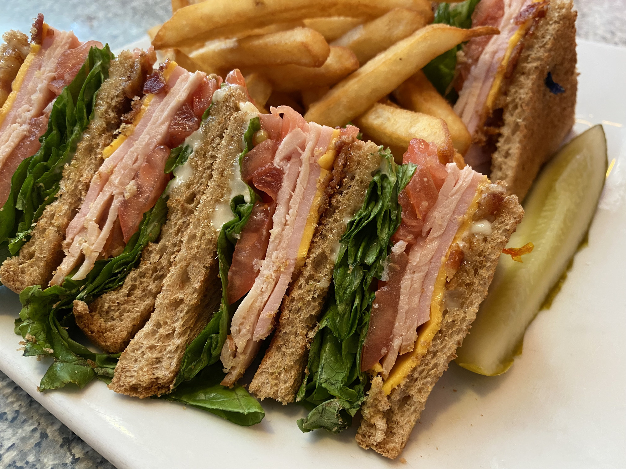 A club sandwich and fries.